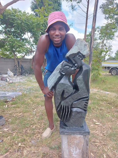 CN Zinyeka posing with his statue