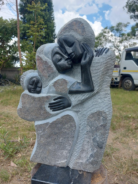 stone sculpture, young family with baby
