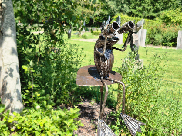 kikkers op tuinprikker, met verrekijker